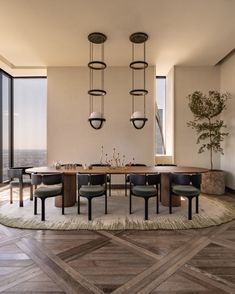 a dining room table surrounded by chairs in front of large windows