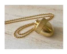 This lovely, solid gold brass acorn necklace is a beauty.  The golden brass acorn screws open to reveal a place to hide pills, messages, money or a sentimental memento.... even a marriage proposal!  This necklace is suitable for a woman or a man and either a golden brass rolo chain or a black and brass cable chain can be chosen at checkout.  The chain is strung through the top of the acorn to make the look more streamlined. If you are looking for a gift for the difficult to buy for, this is it! Man Gifts, Acorn Necklace, Chit Chat, Marriage Proposal, Secret Messages, Black And Brass, Initial Charm, Look Plus, Personalized Jewelry