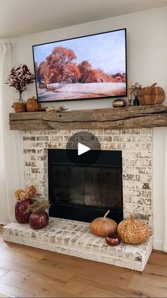 a fireplace is decorated with fall decorations and a flat screen tv