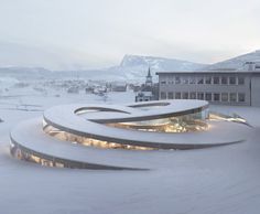 the building is surrounded by snow and has many circular lights on it's sides