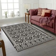 a living room with a couch and rug on the floor