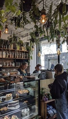 people are standing in front of a bakery counter