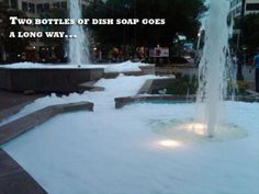 there is a fountain with water spouting out of it and the words two bottles of dish soap goes a long way