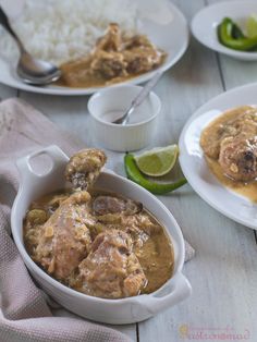 several plates of food on a table with rice and limes next to each other