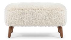 the foot stool is made out of sheepskin and has wooden legs, with an uphol