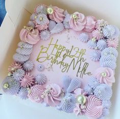 a pink and purple birthday cake in a box with the words happy birthday on it