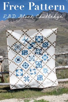 a white and blue quilt sitting on top of a wooden bench