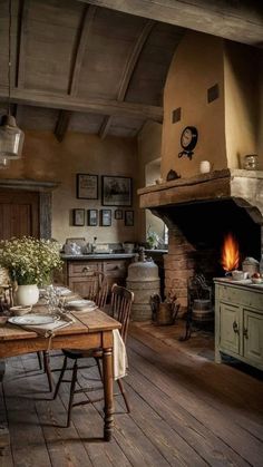 an old - fashioned kitchen is furnished with rustic furniture and wood flooring, along with a fireplace