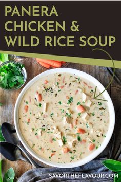 a white bowl filled with chicken and wild rice soup on top of a wooden table