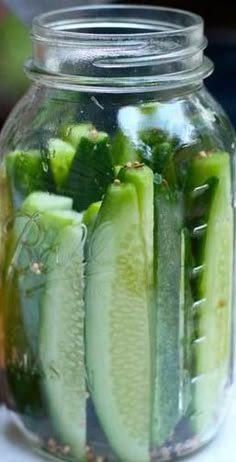 pickled cucumbers in a mason jar on a table