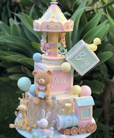 there is a cake made to look like a carousel with teddy bears and balloons on it