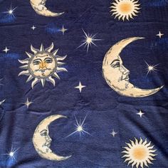 the sun and moon are depicted on this blue blanket with stars in the night sky