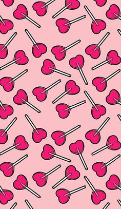 pink lollipops on white background with black and red lines in the middle