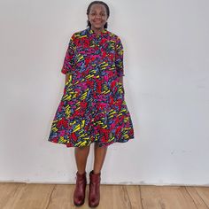 The Confetti dress. Our loose fit colourful dresses made out of non-stretchy African print are perfect for you in case you are looking for a style idea that is versatile, comfortable, and looks fabulous year-round. All materials used to design the dresses are sourced in Kenya.  MEASUREMENT GUIDE:  We recommend asking questions about sizes or you can take your own measurements (at the bust) if unsafe. Since its an A- Line, you only need to ensure that you have the right fit for the bust. Please s Casual Multicolor Printed Shirt Dress, Multicolor Midi-length Dress With Pockets, Multicolor Midi Length Dresses With Pockets, Multicolor Midi Dress With Pockets, Multicolor Printed Collared Shirt Dress, Multicolor Casual Dresses For Work, Casual Multicolor Dresses For Work, Casual Multicolor Dress For Work, Casual Short Sleeve Midi Dress With Vibrant Print