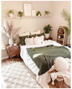 a bedroom with white and green bedding, plants on the wall, and wicker baskets