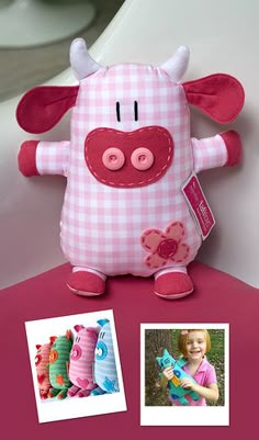 a pink and white pig stuffed animal sitting on top of a table