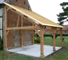 an old brick building with a wooden roof