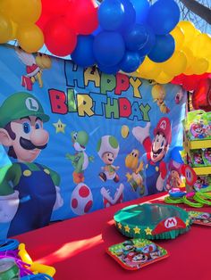 a mario birthday party with balloons and decorations