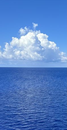 an ocean view with clouds in the sky and blue water on both sides that is almost empty