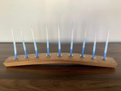 a wooden stand with blue candles on it