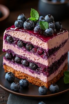 a layered cake with blueberries and cream on top