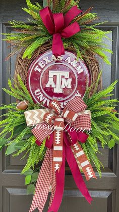 the front door wreath is decorated with red and white footballs, greenery, and a monogrammed bow