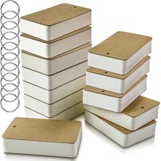 several white boxes with brown lids are stacked on top of each other and one is empty