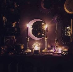 a table topped with candles next to a mirror and other items on top of it