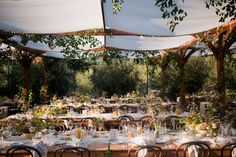 an outdoor dining area with tables and chairs set up for a formal dinner or party