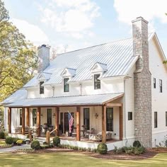 a large white house with an american flag on the porch