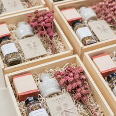 four wooden boxes filled with different types of spices and herbs in them on a table