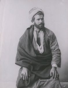 an old black and white photo of a man with a turban