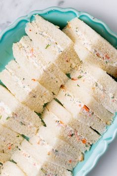 several pieces of white cake on a blue plate with sprinkles and seasoning