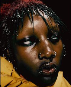 a woman with piercings on her face and nose