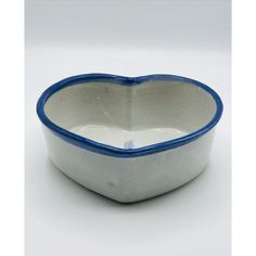 a white and blue heart shaped bowl on a table