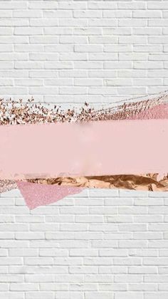 a white brick wall with pink and gold foil paint on it's edges that have been painted over