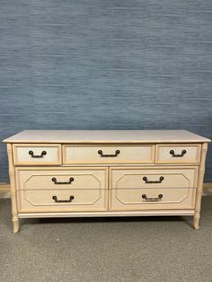 a white dresser sitting in front of a blue wall