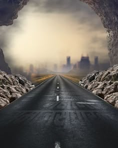 an empty road in the middle of a desert with buildings on both sides and dark clouds above