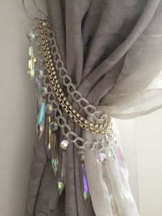 a curtain with chains hanging from it's side and some beads attached to it