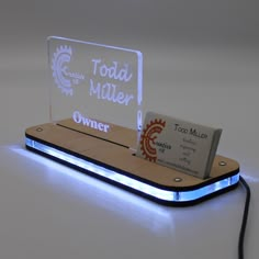 a light up business card holder sitting on top of a table