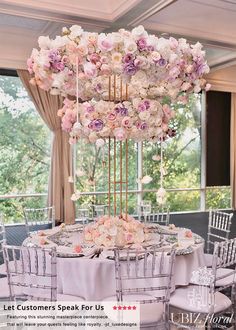 a round table with chairs and flowers on it