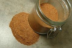 a glass jar filled with sand sitting on top of a table