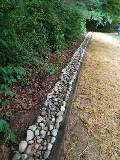 there is a long line of rocks on the side of the road