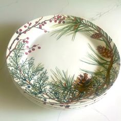 a white plate with pine cones and berries on it