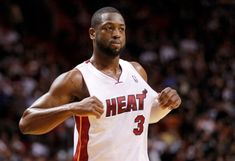 a close up of a basketball player with his fist in the air while wearing a jersey that says heat