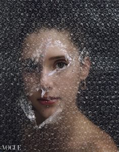 a woman's face is covered in water droplets