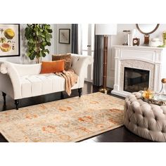 a living room filled with furniture and a rug on top of a hard wood floor