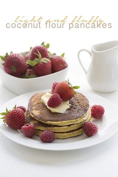 a plate topped with pancakes covered in butter and strawberries