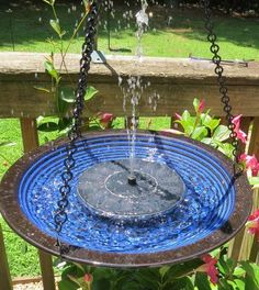 a bird bath with water pouring out of it