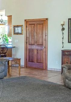 a living room filled with furniture and a wooden door